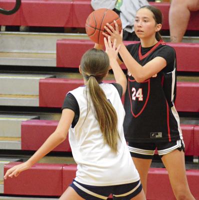 BRYLEE CASTILLEJA (right) looks to pass while closely guarded on the wing during Richmond’s girls basketball clash with Meadville in River Valley Shootout action. SHAWN RONEY | Staff