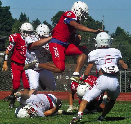 RICHMOND COACH Nick Persell expects Keyshaun Elliott, shown in midair during the 2020 Red and White Game, to apply the knowledge he acquired about quarterbacking in high school to playing linebacker in the NFL. SHAWN RONEY | Staff