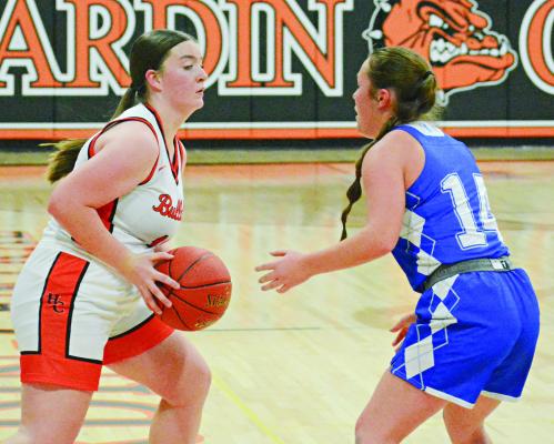 LILLY LYON (left) looks to pass for Hardin-Central while guarded by Tri-County’s Aliee Prescott. SHAWN RONEY | Staff