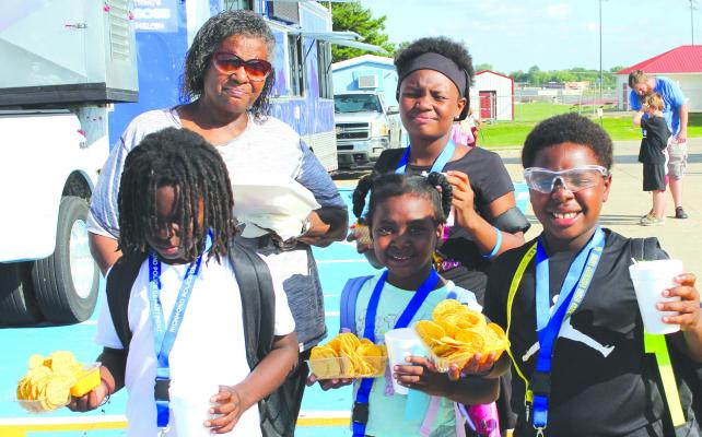 MARTHA STANDLEY (from left), Courtland Caroline, Chani Underwood, Royalty Caroline and Leslie Caroline grab nachos before heading home.