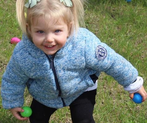 LONDON REYNOLDS collects as many eggs as she can hold. SHARON DONAT | Staff