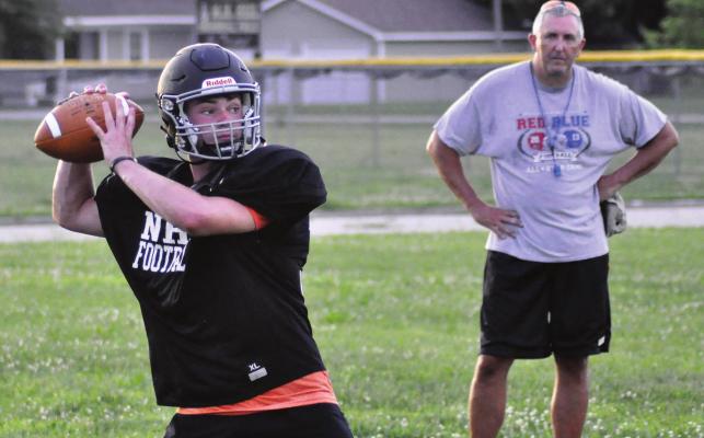WITH LONGTIME COACH Kirk Thacker watching, Norborne Hardin-Central quarterback Brayden Schick rears back to throw a wide receiver screen pass Monday at Norborne. SHAWN RONEY | Staff