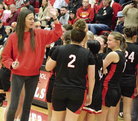 RICHMOND COACH Kaylee Vantrump (left) exchanges high fives with the Spartans after they win the girls portion of the Lawson Invitational Tournament title. SHAWN RONEY | Staff