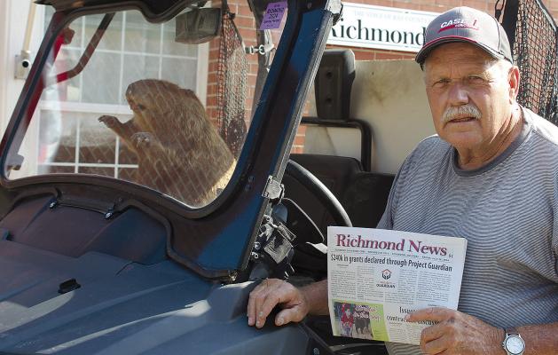 LARRY WILLIAMS and his travel companion, Luther, swing by to pick up a newspaper. SHARON DONAT | Staff