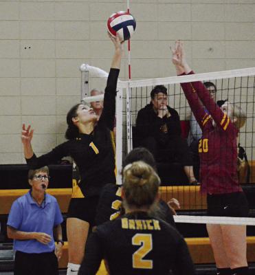 ORRICK SENIOR Anela Fletcher (No. 1) attempts to tip over Kansas City Lutheran’s Kate Mahnken recently in home varsity volleyball action. SHAWN RONEY | Staff