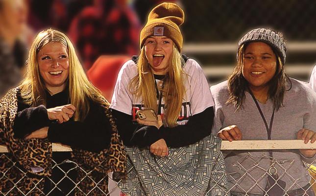 FANS ENCOURAGE the Richmond Spartans to fight onward to victory. Among those having fun at the Nov. 5 home playoff game are, from left, Emily Duncan, 15; Emma Craig, 16; and Tiara Smith, 15. J.C. VENTIMIGLIA | Staff