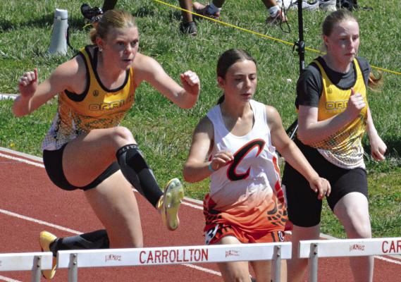 ADDISON CHAPMAN (left) fights for the lead in the girls 100-meter high hurdles at Class 1 District 4 competition. Also shown is Orrick teammate Natalie Cox (right). SHAWN RONEY | Staff