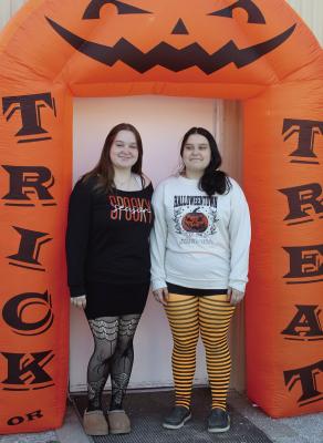LILLIAN (LEFT) AND Kandence Quick welcome visitors to the haunted house at the Hardin Police Station. SHARON DONAT | Staff