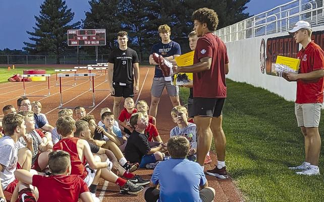 CAMP ATTENDEES listen to the advice given about football and life from local college students. Submitted