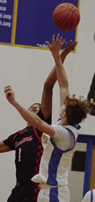BRICE DOME (left) goes up for the tipoff during Richmond’s third-place game with Lafayette County of Higginsville.