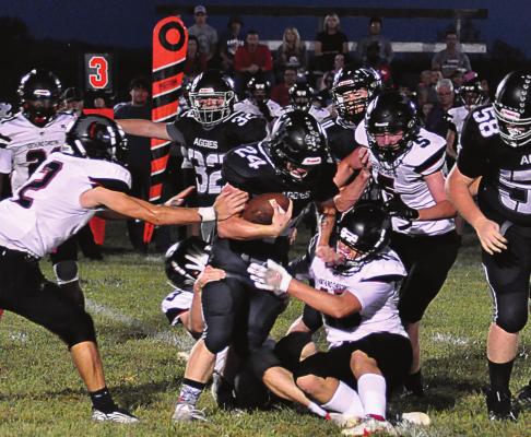 KELTON GORDON, a Hardin-Central junior, takes on a gang of Trailblazers as he carries the ball during the first half of Norborne Hardin-Central’s Oct. 1 homecoming meeting with Northland Christian at Norborne. SHAWN RONEY | Staff