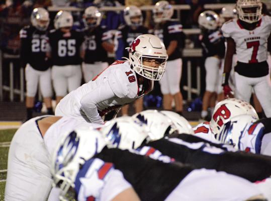 RICKY RUSS (No. 18) peers over the line of scrimmage, ready to attack, during the second of Richmond’s Oct. 6 road meeting with Holden. SHAWN RONEY | Staff