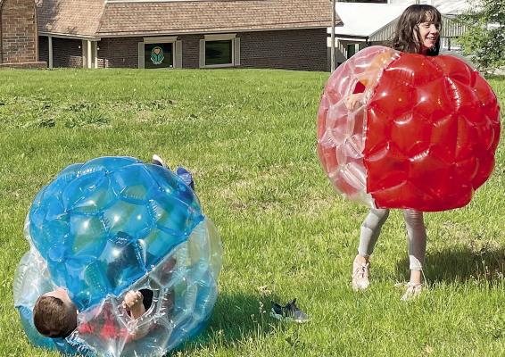 SOPHIA BALES | Staff BRAXTON GALARIADA (left) rolls in his bubble after his sister,Ryley, bumped him during the CAP event at Maurice Park in Richmond.