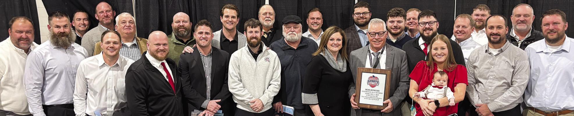 SURROUNDED BY FAMILY AND FRIENDS, Coach Rob Bowers (holding plaque) is inducted into the Missouri Sports Hall of Fame. Submitted