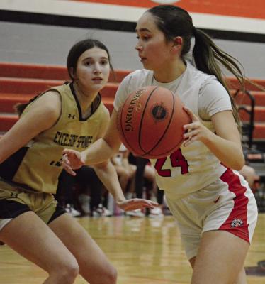 RICHMOND SOPHOMORE Brylee Castilleja (right) attempts to drive past Reese Ryan of Excelsior Springs in Class 4 District 14 girls basketball action. SHAWN RONEY | Staff