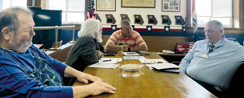 RAY COUNTY COMMISSIONERS GARY WILHITE, Dave Powell and Billy Gaines discuss the rebranding of Ray County Memorial Hospital. Hospital CEO Jeff Bloemker (right) is seeking letters of support. SOPHIA BALES | Staff