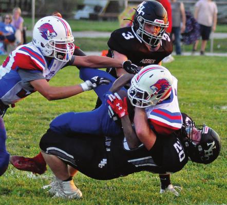 JUNIOR PEYTON MEIERER, No. 20, makes a first-half tackle for the Aggies during their Week 1 meeting at Hardin-Central with Kansas City East Christian, a Kansas-based program consisting of homeschooled students. SHAWN RONEY | Staff