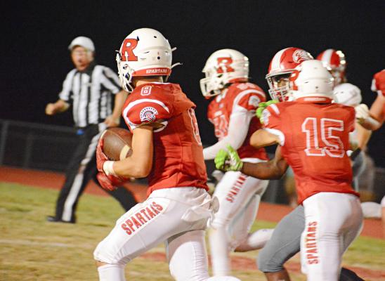 BAILON STOCKTON keeps the football tucked in his left arm as he takes a fourth-quarter interception to the house Sept. 16 against visiting Van Horn. SHAWN RONEY | Staff