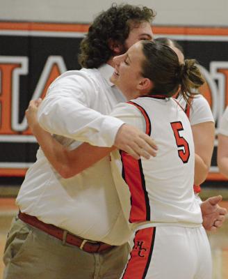 HARDIN-CENTRAL SENIOR Ester Kincaid (right) receives a hug from her coach, Tommy Burton, after she surpasses 1,000 career points. SHAWN RONEY | Staff