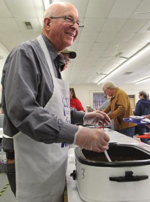BOARD MEMBER Kenneth Nolker fills bowls and keeps the line moving.