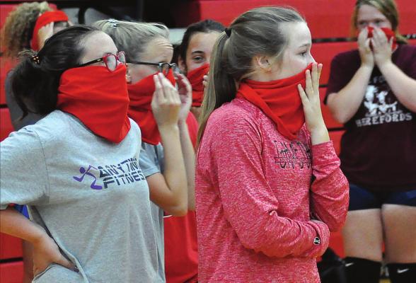 THE RICHMOND VOLLEYBALLERS adapt to sports in a COVID-19 world, donning their gaiter masks during a break between early-morning practice reps Aug. 21 at Sunrise Elementary School. SHAWN RONEY | Staff