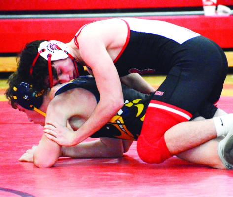 SENIOR JOE BURCH III, top, works to break down Penney of Hamilton’s Hunter Nixdorf Jan. 5 at Richmond High School. SHAWN RONEY | Staff
