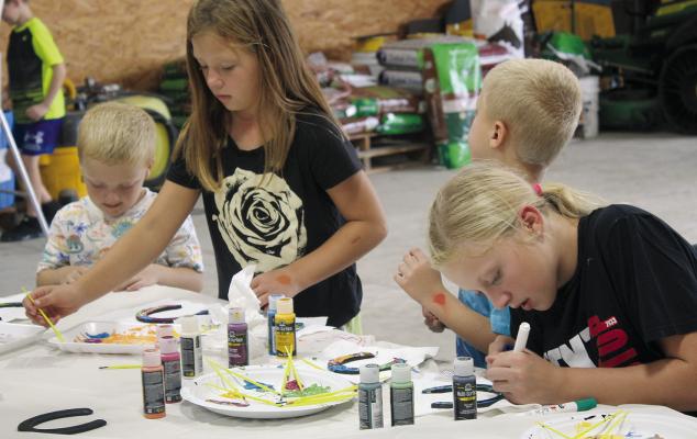 Finn (from left), Olivia, Del and Annabelle Jones put their creativity to work painting horseshoes at Aldrich Quarter Horses. “I liked the kids who wanted a horse because I was ‘that’ kid,” said Aldrich Quarter Horses Owner Janet Aldrich. “I shared never to give up on working and dreaming for a horse.”