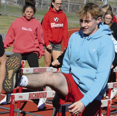 JUNIOR NOLAN QUICK, shown stepping sideways over hurdles, is among about 70 high schoolers out for track and field at Richmond. SHAWN RONEY | Staff