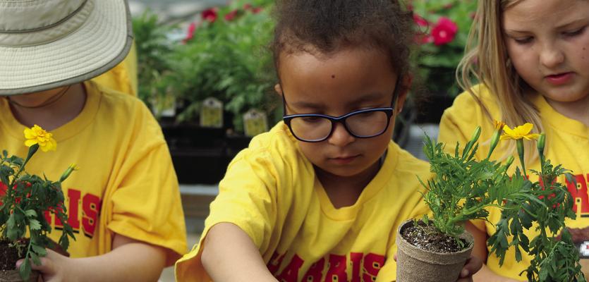 DEAR ELEMENTARY students Elena Strickler (center) and Charlee Sisson (right) learn how to properly care for plants. SHARON DONAT | Staff