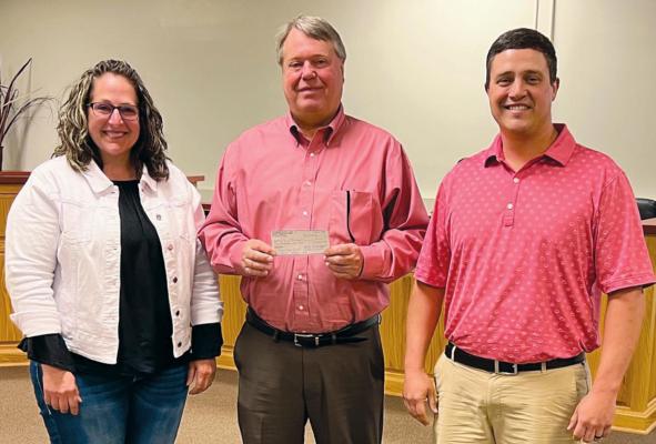 RICHMOND ROTARY members Becky Treccariche, left, and Doctor Ryan Lauck, right, present Mayor Mike Wright with a donation of $5,000 for the developing park project at North Main and College streets. Submitted