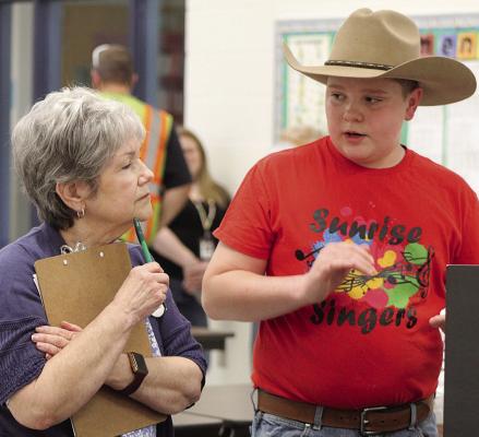 CARSON BURK (right) explains his science fair project to the judge, Janine Misenhelter. SHARON DONAT | Staff