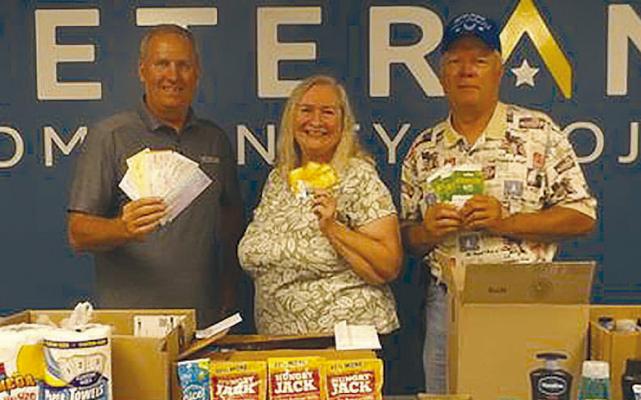 CHRIS ADMIRE (from left) accepted donations from OCC members Barbara and Mike Britt. Submitted