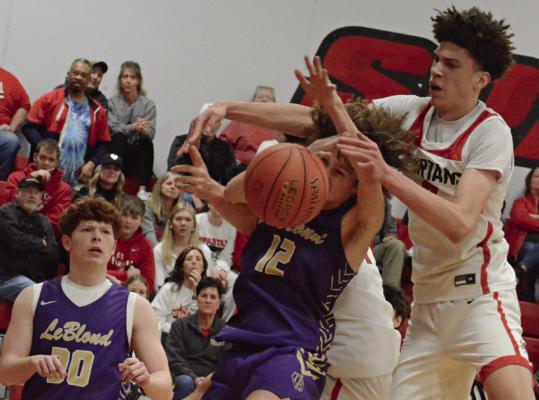 JACKSON CREWS of Bishop LeBlond (left) watches as teammate Cooper Waterman and Richmond senior Gabe Johnson (right) fight for a 50/50 ball. SHAWN RONEY | Staff