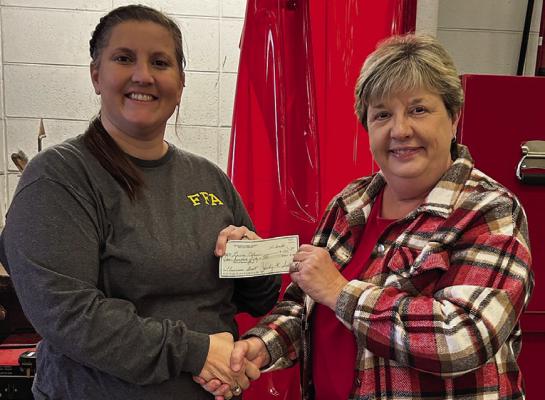 RICHMOND HIGH SCHOOL teacher Laura Allen (left) is awarded a $150 Classroom Impact Grant from Beta Tau representative Brenda Hamm to purchase three autodarkening welding helmets. Submitted