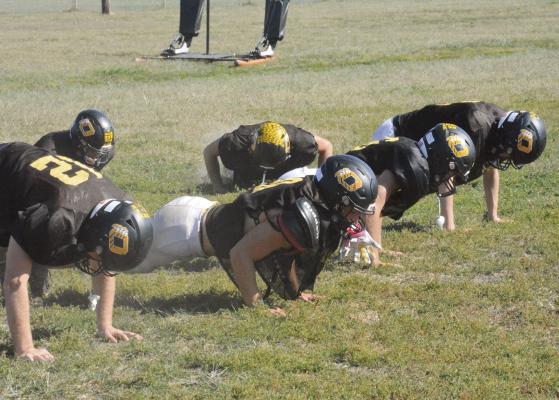THE BEARCATS do up down exercises Tuesday on their practice field as they work toward their goal of posting a perfect season. They’ll attempt to take another step toward that goal Friday night, when they host Sweet Springs/ Malta Bend for homecoming. SHAWN RONEY | Staff