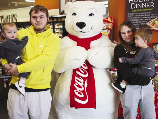 Kaison, CJ, Delia and Arrow Barber enjoy the festivities at a local food store in Richmond. The Coca-Cola Polar Bear made its appearance in Ray County along with Santa Claus and the Grinch. SOPHIA BALES | Staff