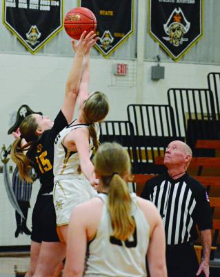 ORRICK SENIOR Natasha Hicks (No. 15) reaches high during the opening tipoff against Norborne.