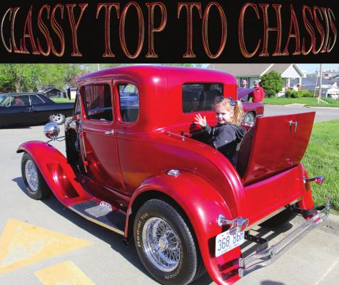 IN THE RUMBLE SEAT of a 1929 Ford Model A, Mercy Bolling, 3, waves to a family member. The vehicle belongs to Michelle Glunt, Excelsior Springs. J.C. VENTIMIGLIA | Staff