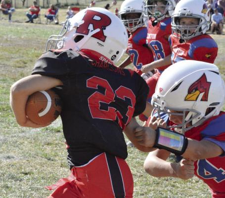 CALLING TO MIND Richmond High School running back Aidan Ivison, who also wears No. 23, Roman Charlons breaks a tackle as he rumbles for rushing yards during the second half of the Richmond third-grade team’s Oct. 22 meeting with Clinton in the West Central Youth Football League playoff semifinals at Dear Elementary Field. SHAWN RONEY | Staff