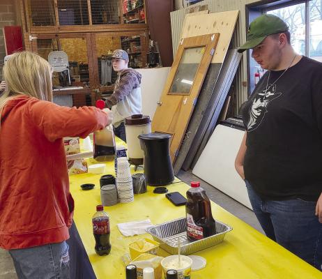 JAKE MCMILLIAN (left) and Anthony Covey serve attendees.