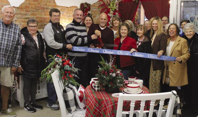 CHAMBER MEMBERS and community members gathered for a ribbon cutting at RnR Designs.