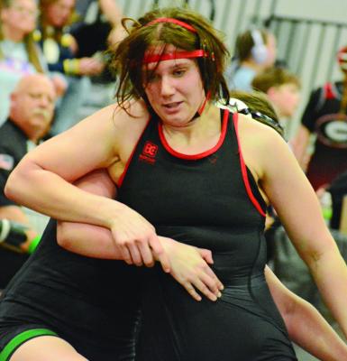 HAVING RISEN from the bottom position, Richmond sophomore Taylor Baker works to break the hold by Mid-Buchanan’s Vivian Stockbauer and score an escape during the wrestleback semifinals at the Class 1 District 4 Tournament. SHAWN RONEY | Staff