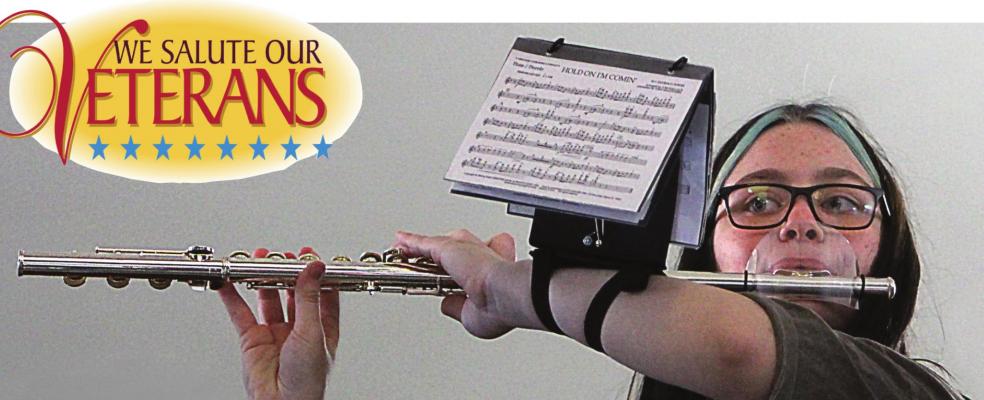 RICHMOND High School Band member Savanna Ray performs for Veterans Day at the Ray County Courthouse. Her flute includes a mouth guard to help prevent the spread of COVID-19. More pictures on pages 10-11.