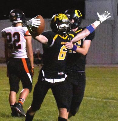 FOOTBALL FIRMLY in hand, Orrick senior Blake Buchanan has reason to cheer, as he and his fellow Bearcats contain Northwest/Sacred Heart’s passing attack and roll to a 68-26 Sept. 24 home victory. TARA ALTIS | Staff affiliate