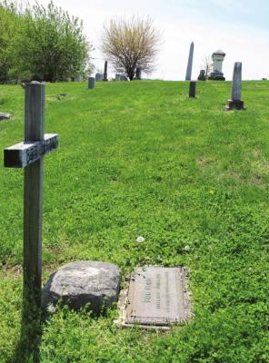 A WOODEN CROSS marks the spot in the Richmond Cemetery where Jesse James’ assassin, Robert Ford, is buried. J.C. VENTIMIGLIA | Staff