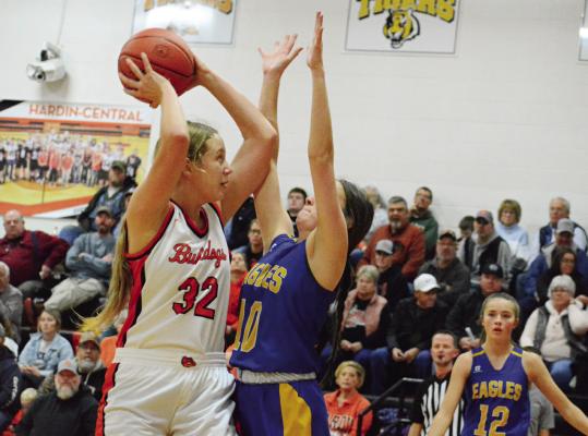 WITH NORTHWESTERN OF MENDON senior Maisy Adams guarding her and Lily Willis, a Northwestern first-year high schooler watching, Hardin-Central sophomore Zoey Polk looks to shoot during the Bulldogs’ 53-23 Dec. 15 home win. SHAWN RONEY | Staff