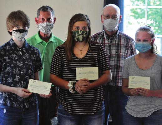 WEARING COVID-19 masks, front, from left, are Genevieve Keighly, Kassie McGinnis and Ashley Stewart. They display their Ray County Fair Harold Strobel Citizen of Service awards. Behind them stand Frazer Letzig and Ray County Fair representative Dean Richards.