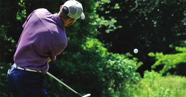 DYLAN COMSTOCK gets some loft on his golf ball Monday at Drumm Farm Golf Course in Independence. SHAWN RONEY | Staff