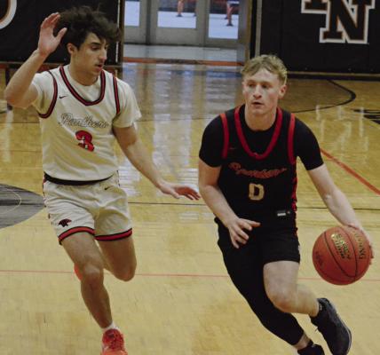 RICHMOND SENIOR Nolan Quick (right) pushes the tempo as Oak Grove senior Maddox Carillo tries to keep up with him during Class 4 District 14 boys basketball action. More game photos on page 12. SHAWN RONEY | Staff