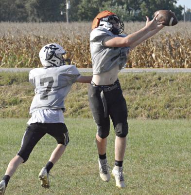 FOLLOWING HIS two-TD performance in Week 3 for Norborne Hardin-Central, Sam Barnett (right) snags a pass Monday on the Hardin-Central practice field while covered by Kaden McGinnis. SHAWN RONEY | Staff
